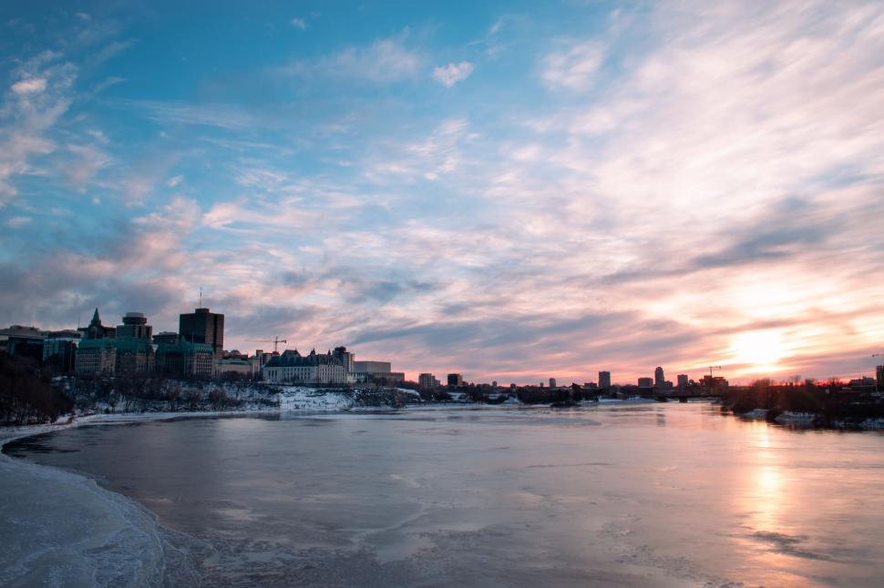 Free Image of City skyline at dusk reflected in tranquil river waters 