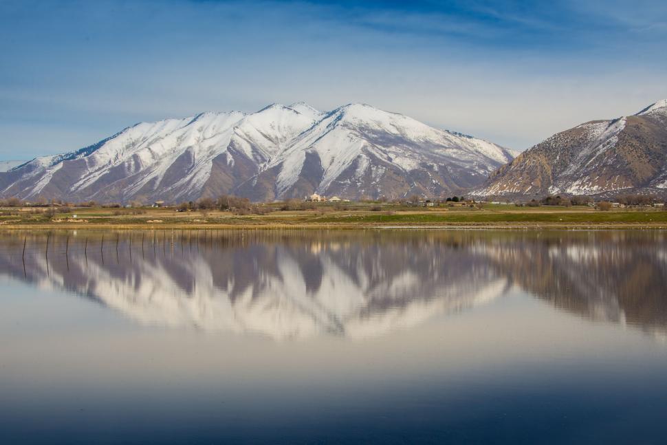 Free Image of Snow-capped mountains mirrored in tranquil lake view. 