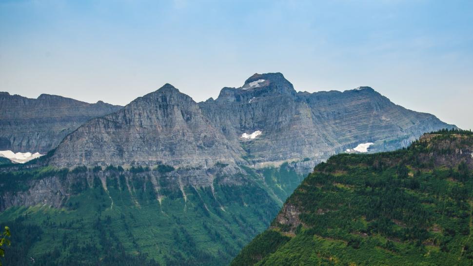 Free Image of Majestic rocky mountains with patches of snow on peaks 