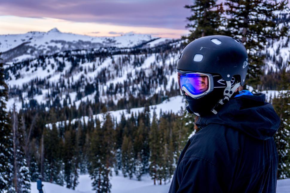 Free Image of Skier dressed in black, gazing over snowy mountain 