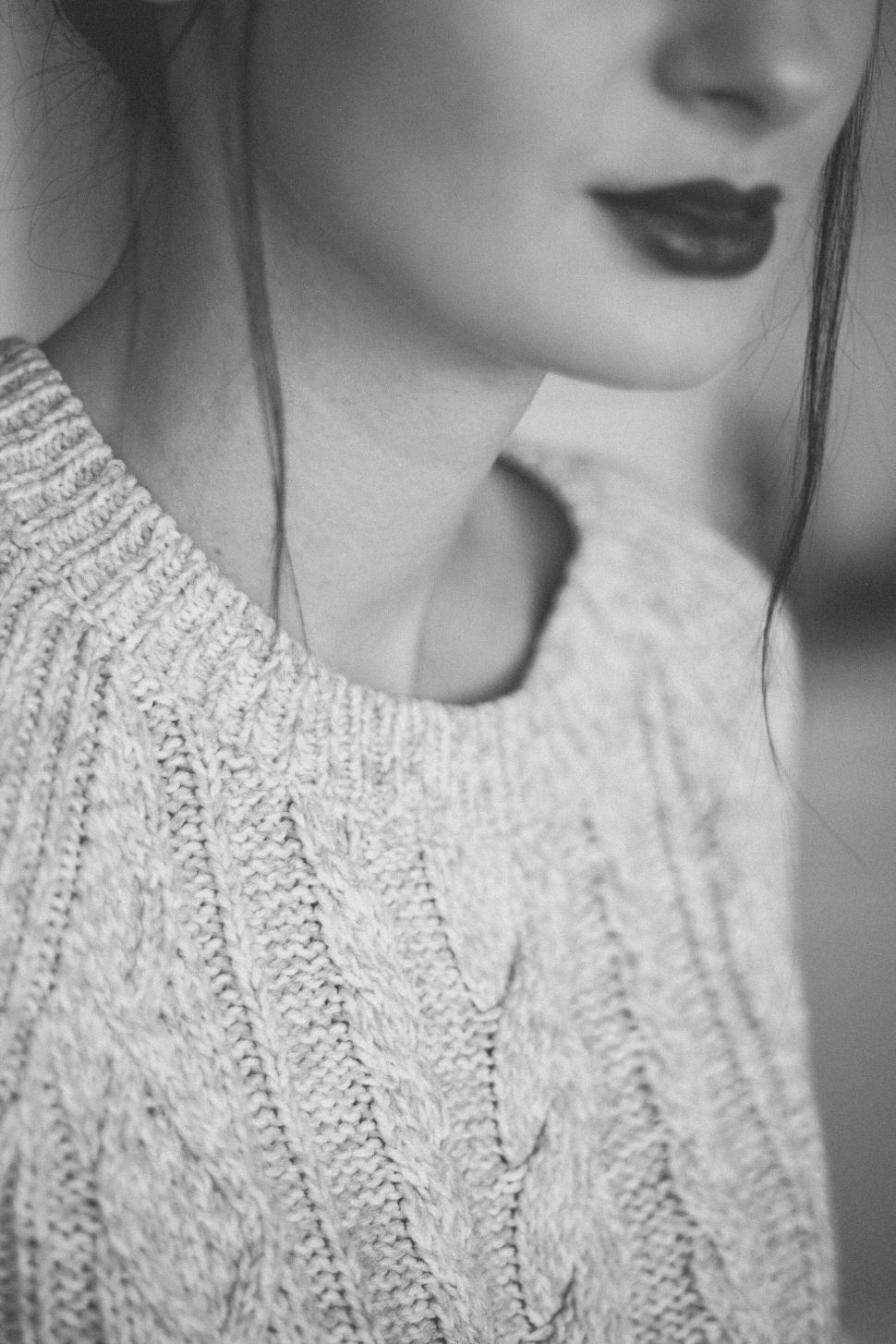 Free Image of Close-up of a person in a cable-knit sweater, cropped. 