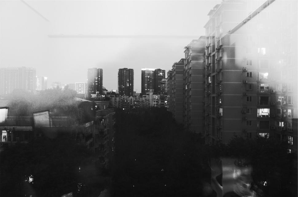 Free Image of City skyline view with tall buildings in black and white 