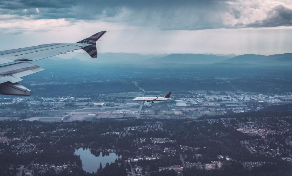Free Image of Aerial view of two airplanes amidst scenic cloudy sky. 