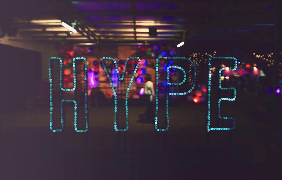 Free Image of Colorful LED lit HYPE sign in dimly lit room 