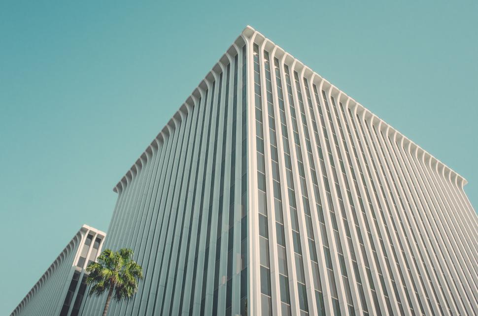 Free Image of Tall and modern building against a clear blue sky 