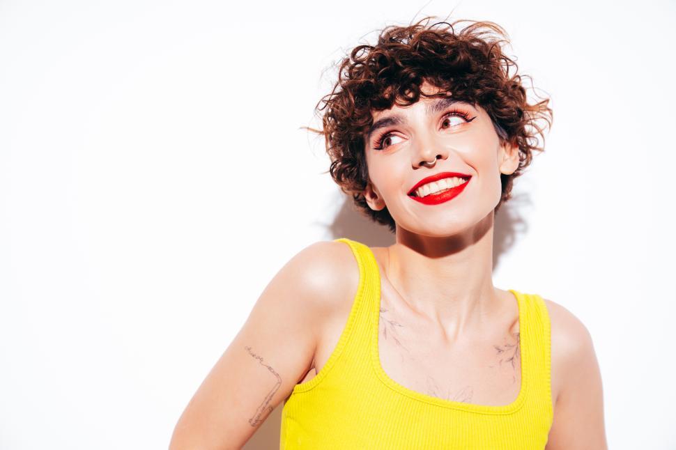 Free Image of Woman in yellow tank top with joyful expression 