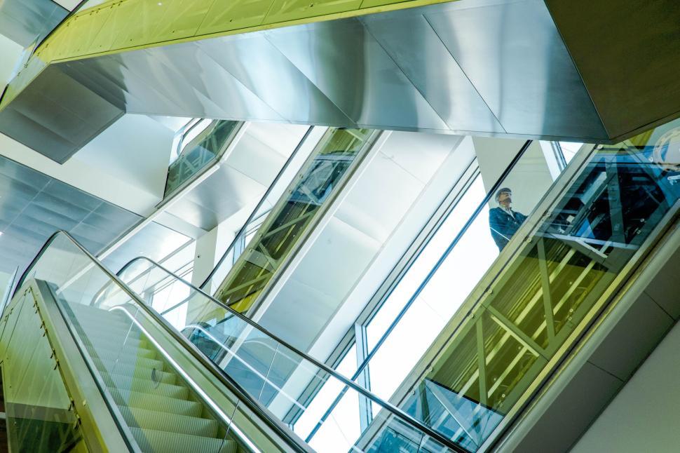 Free Image of Modern escalators and architecture with person 