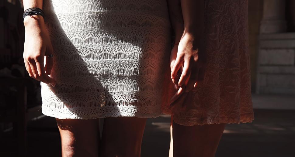 Free Image of Women standing closely together in decorative dresses 