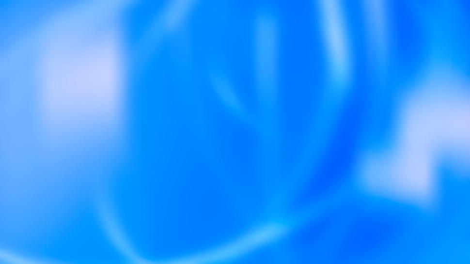 Free Image of Soft blue backdrop with gentle flowing shapes 