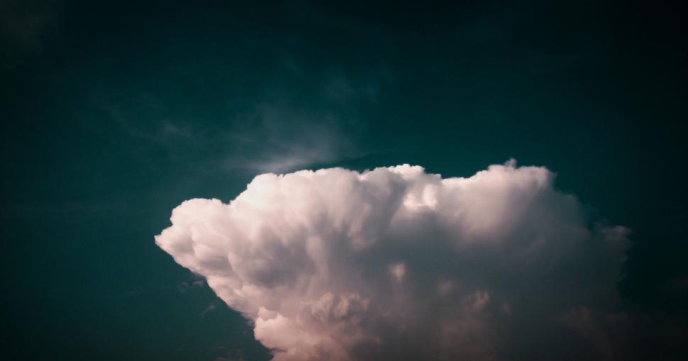Free Image of Large white cloud against the dark sky at sunset 
