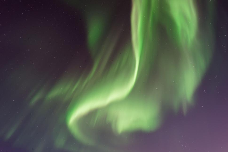 Free Image of Northern lights with green swirls in a night sky. 