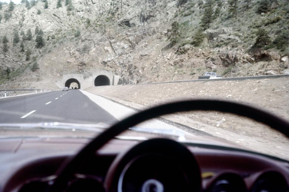 Free Image of Twin tunnels carved into rocky mountainous terrain. 