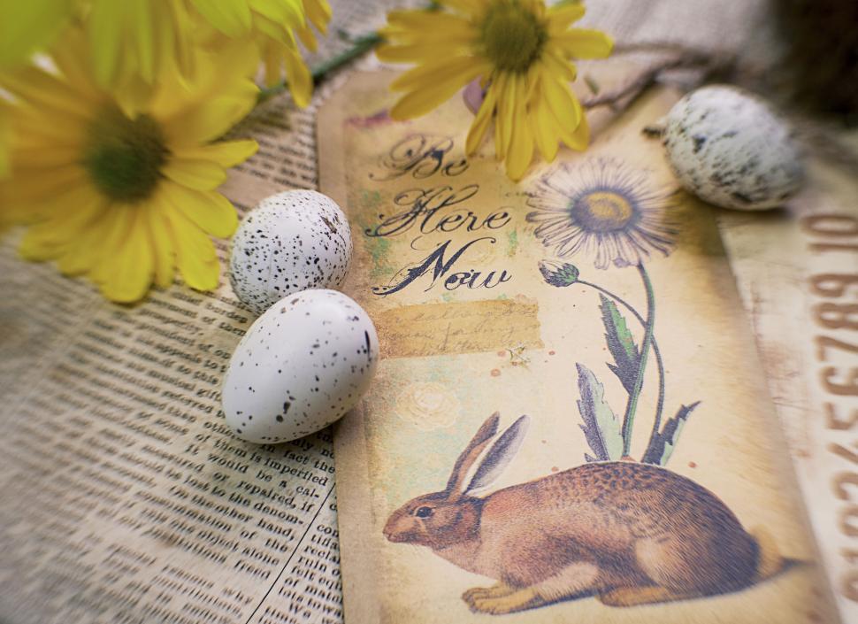 Free Image of Vintage tag with rabbit and flowers on newspaper background 
