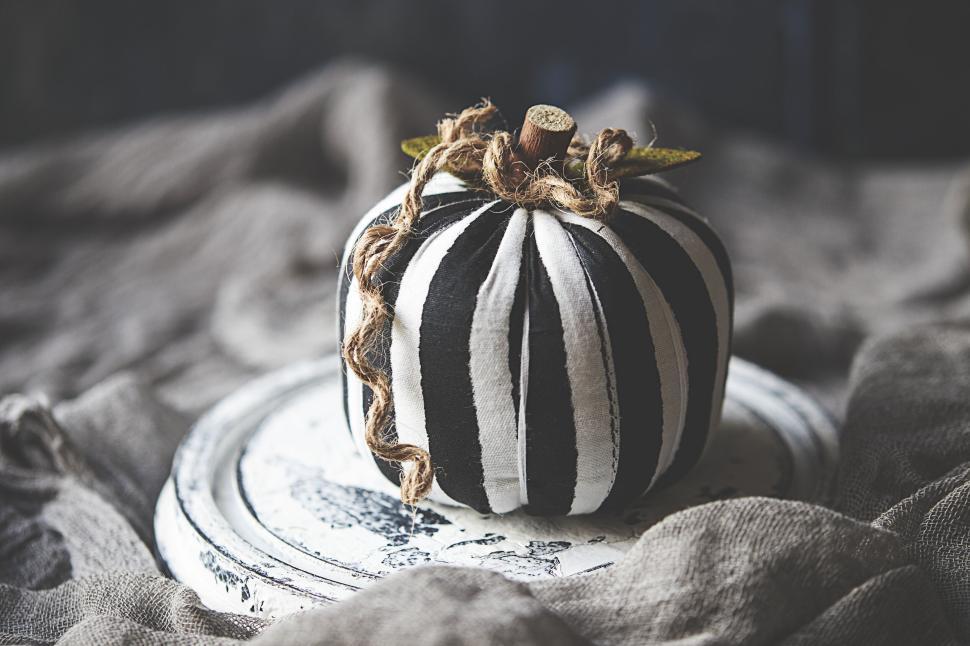 Free Image of Decorative black and white striped pumpkin on plate. 