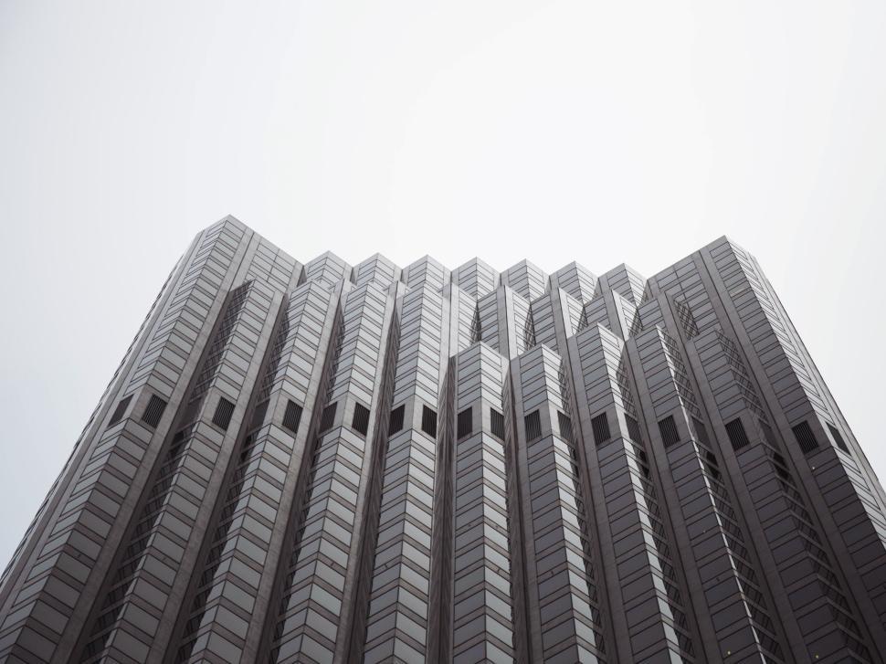 Free Image of Modern skyscraper with geometric design against bright sky 