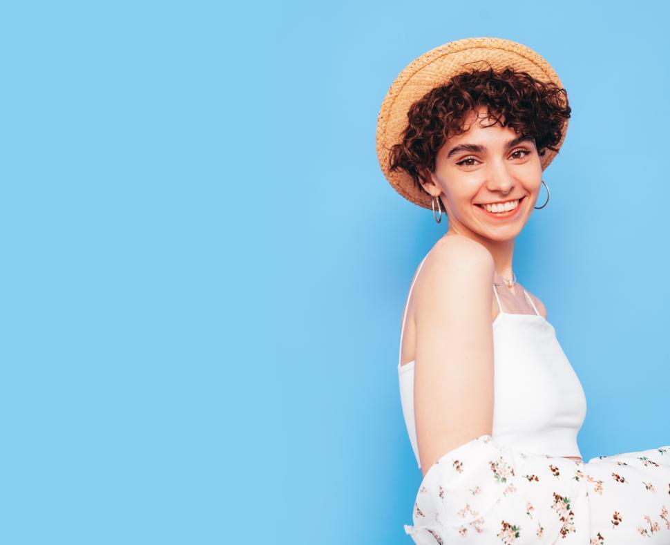 Free Image of Happy woman in casual summer outfit with hat pose 