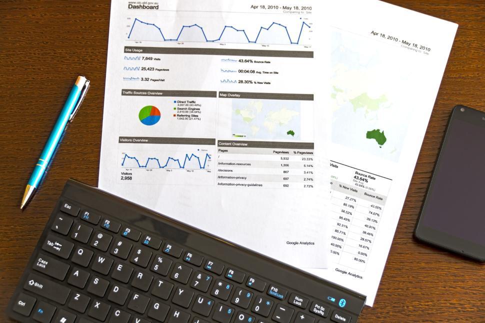 Free Image of Printed analytical charts and graphs with a black keyboard 