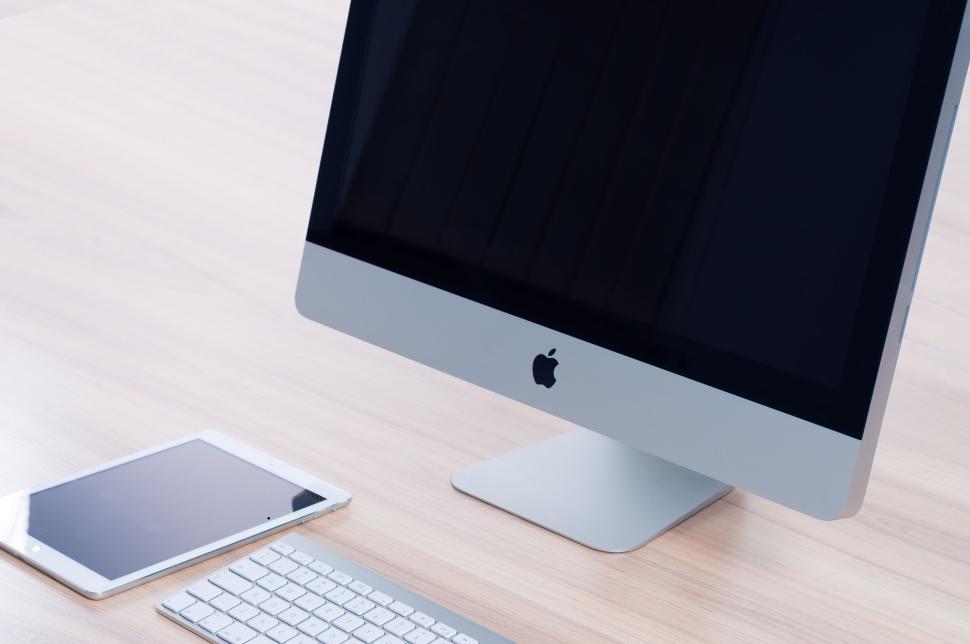 Free Image of IMac and tablet on a minimalist wooden desk setup 