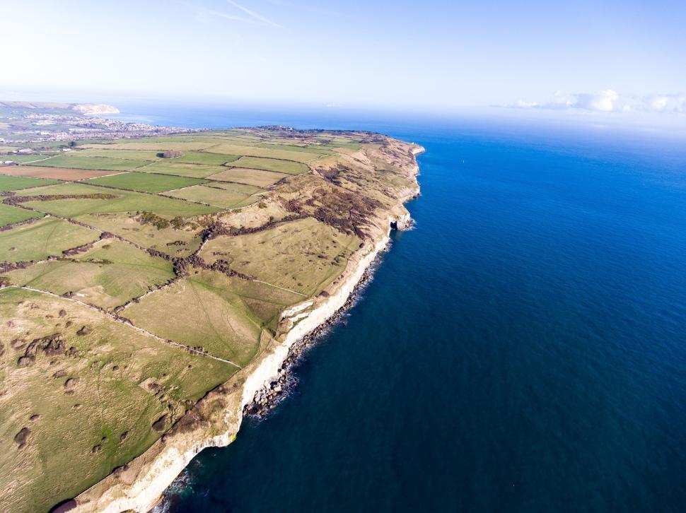 Free Image of Aerial coastal view with cliffs and fields extending. 