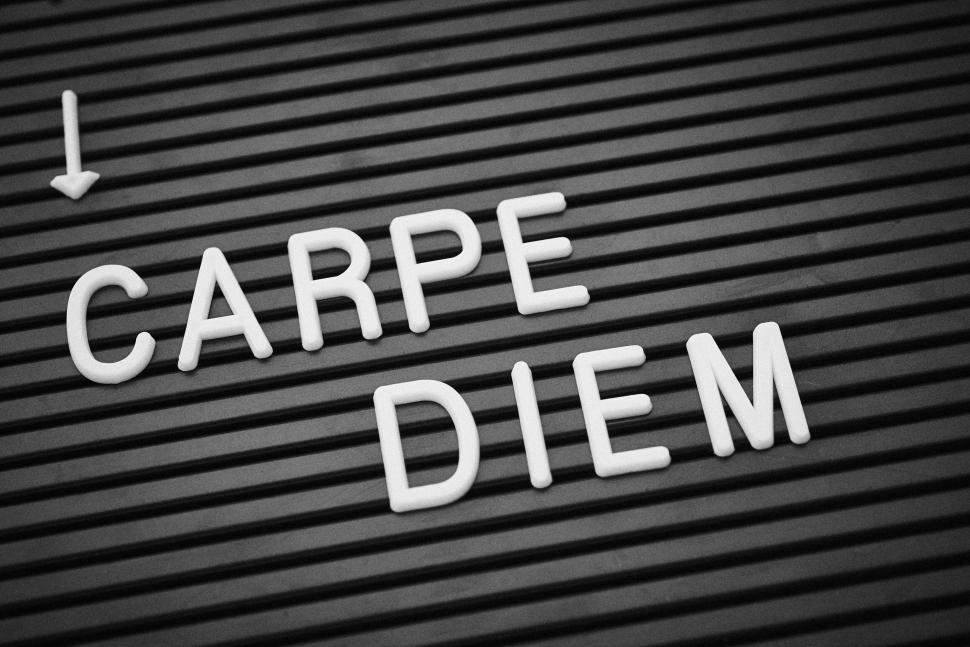 Free Image of White letters spelling  Carpe Diem  on a black board. 