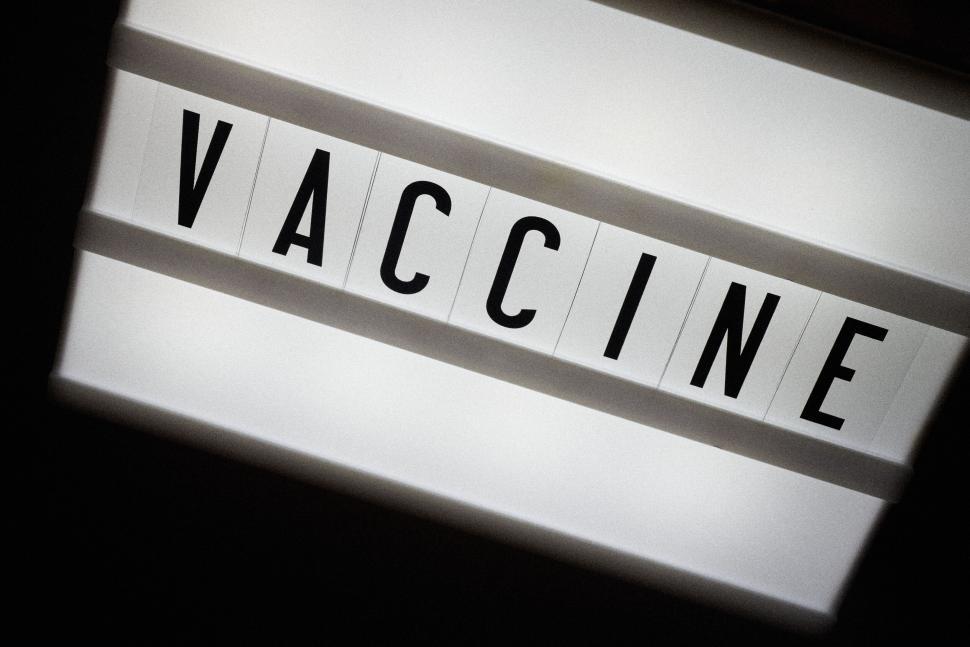 Free Image of Word vaccine displayed in black letters on white lightbox 