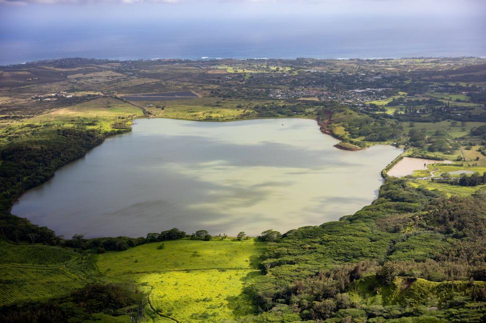 Free Image of Aerial view of lush green landscape with large lake 