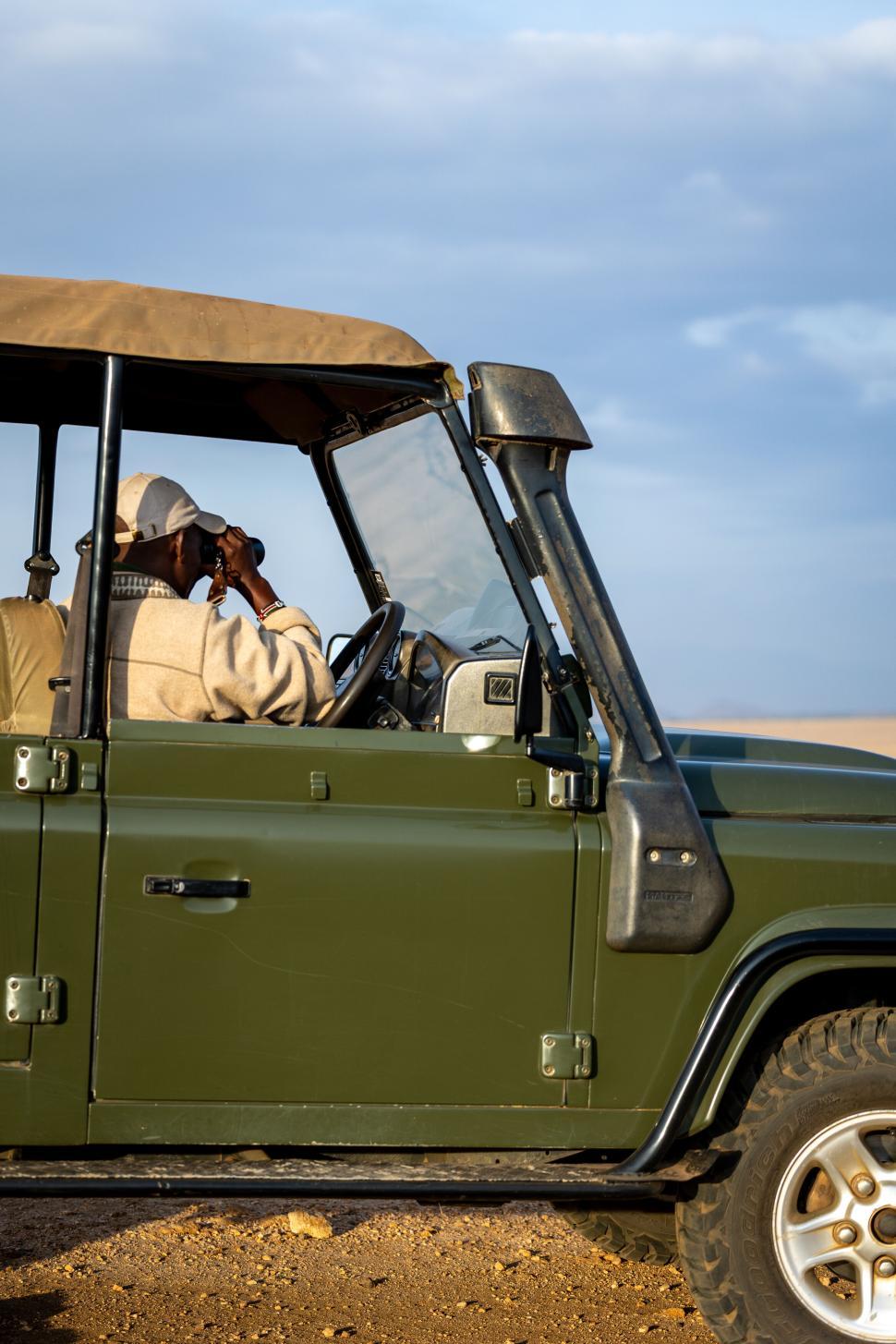 Free Image of Driver with binoculars in off-road vehicle on safari ride. 