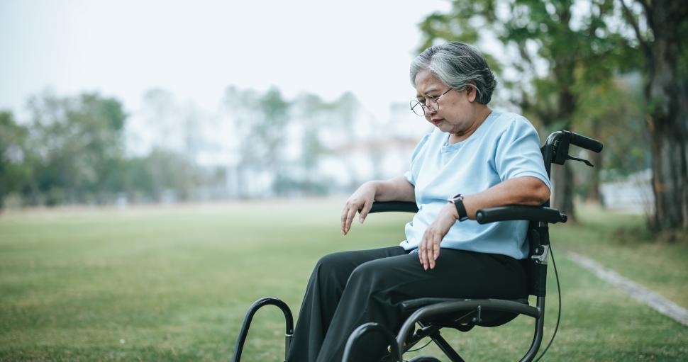 mature-woman-in-wheelchair-having-knee-pain-with-pain-expression-on-face.jpg