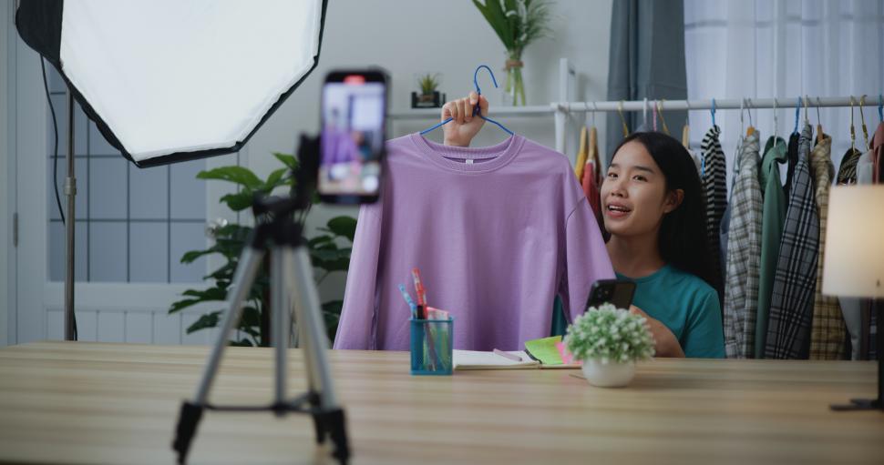 Free Image of Female fashion designer using mobile phone live steaming 