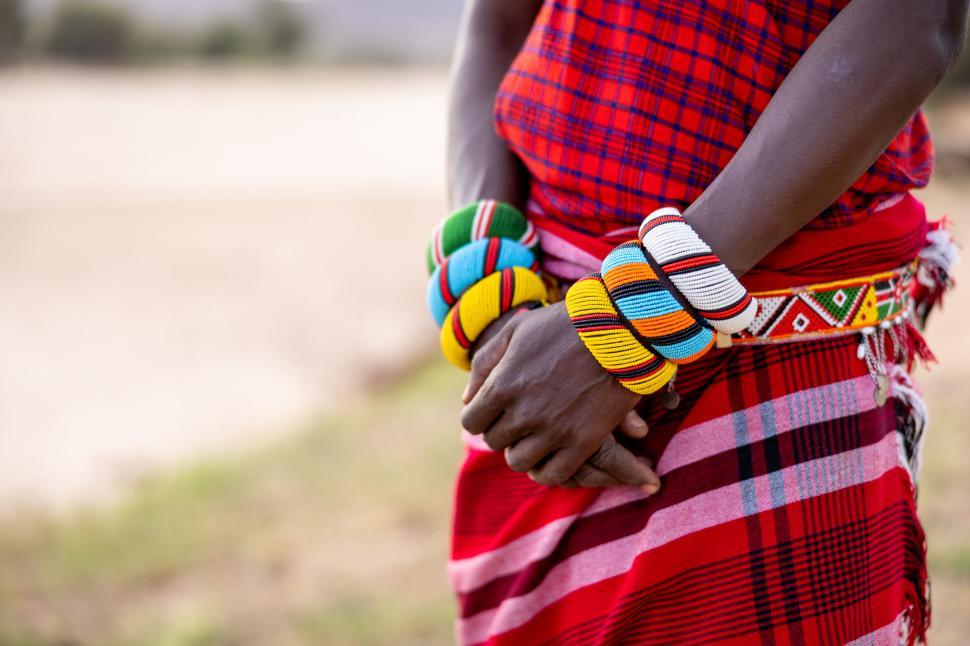 Free Image of Person in traditional colorful attire with bead bracelets 