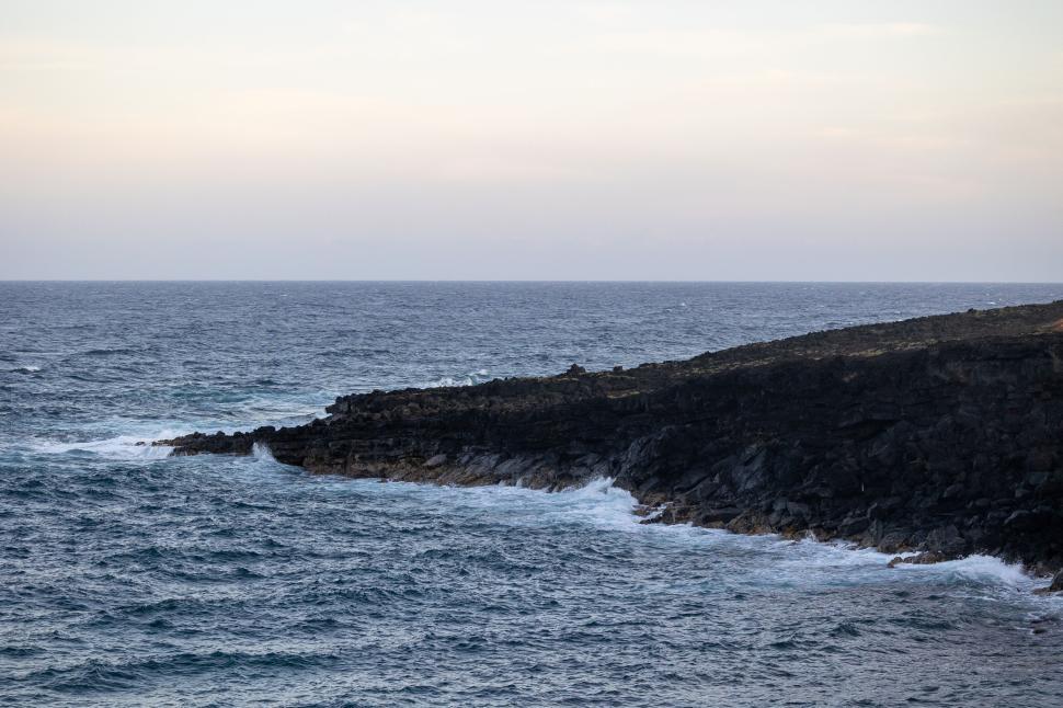 Free Image of Rocky coastline meeting the restless blue ocean. 