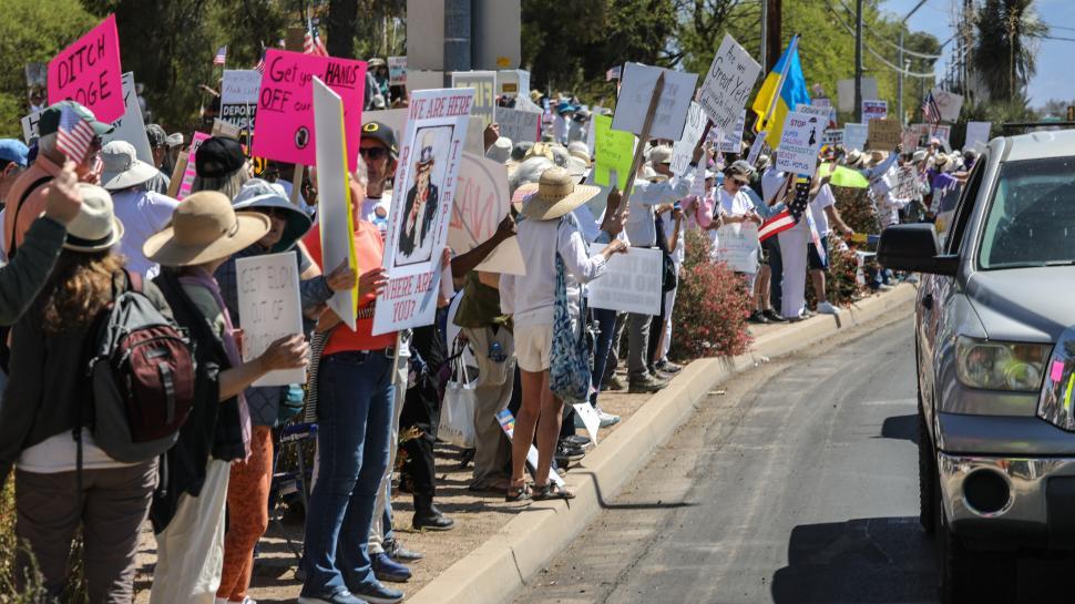 Free Image of Hands Off political protest against Donald Trump in the United States during a sunny day with many demonstrators 