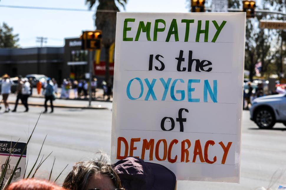 Free Image of Hands off political protest in the United States advocating for empathy and democracy against Donald Trump 