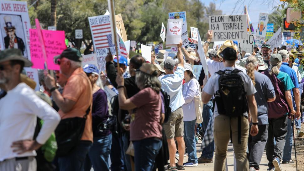 Free Image of Hands off protest against Donald Trump in the United States featuring diverse activists with signs 