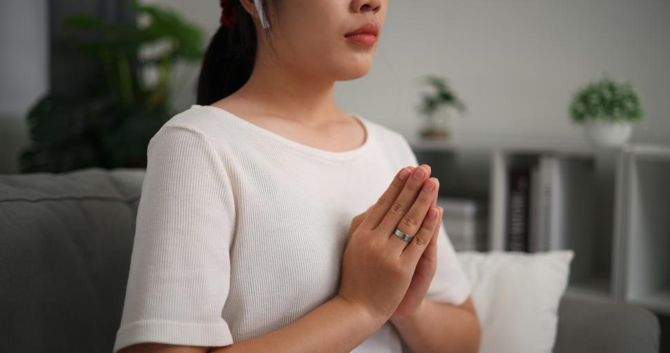 Free Image of Selective focus, Relaxed young woman wear wireless headphones enjoying rest on sofa in living room, breathing fresh air with eyes closed, meditating at home 