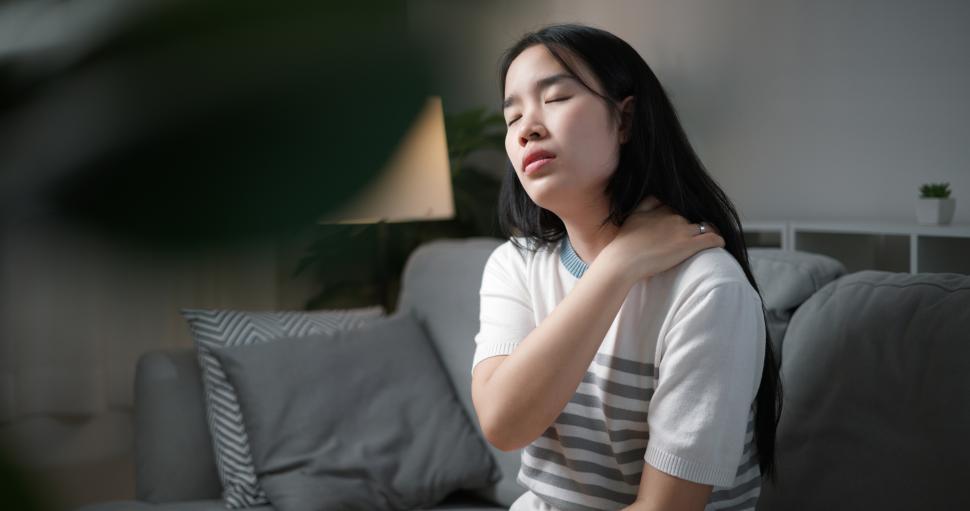 portrait-of-unwell-young-woman-has-neck-pain-while-sitting-on-the-sofa-in-the-living-room.-people-with-muscle-body-problems.jpg