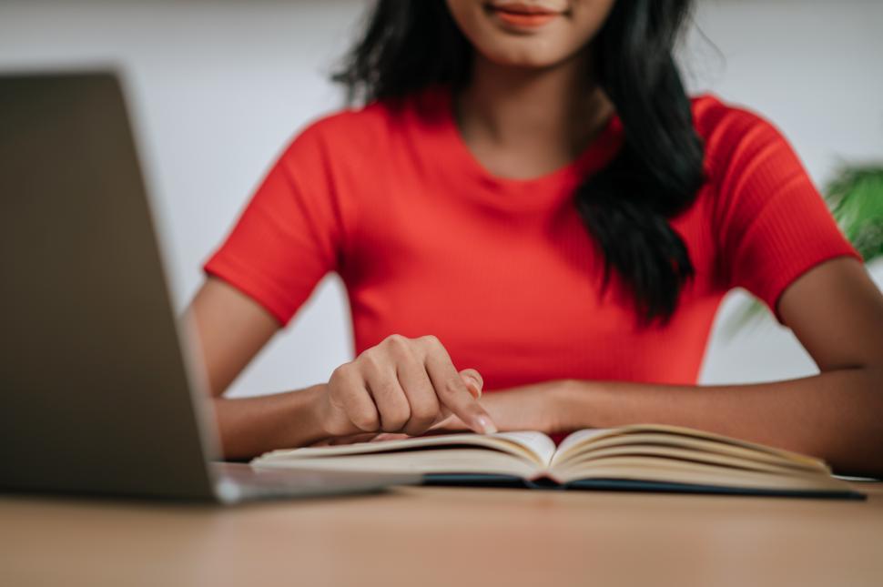 Free Image of A young woman working with a laptop 
