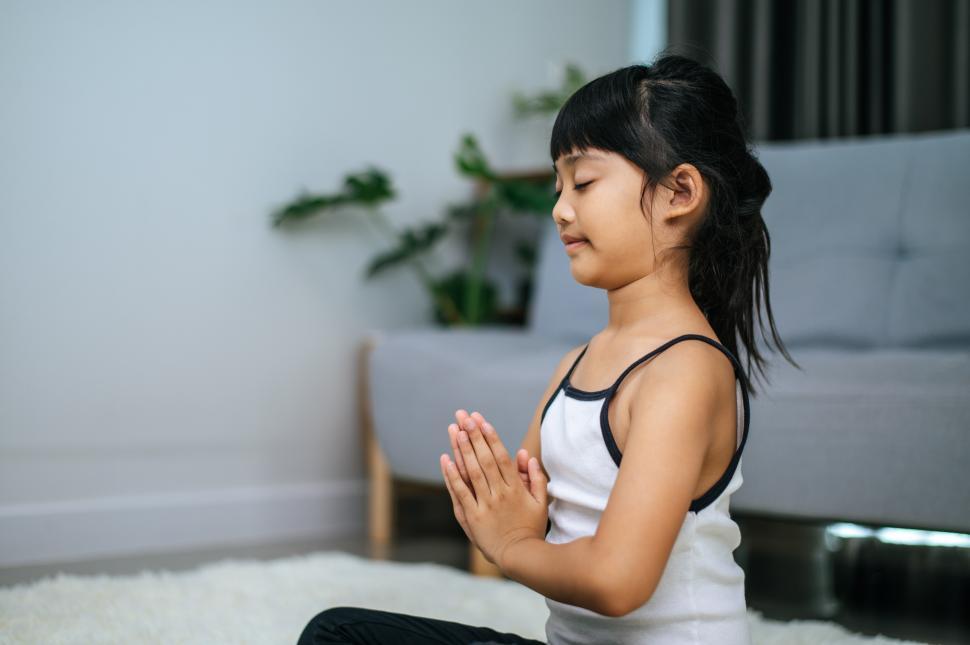 Free Image of girl doing yoga in room on white carpet 
