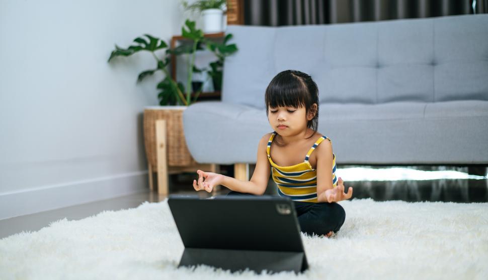 Free Image of girl doing yoga in room on white carpet 