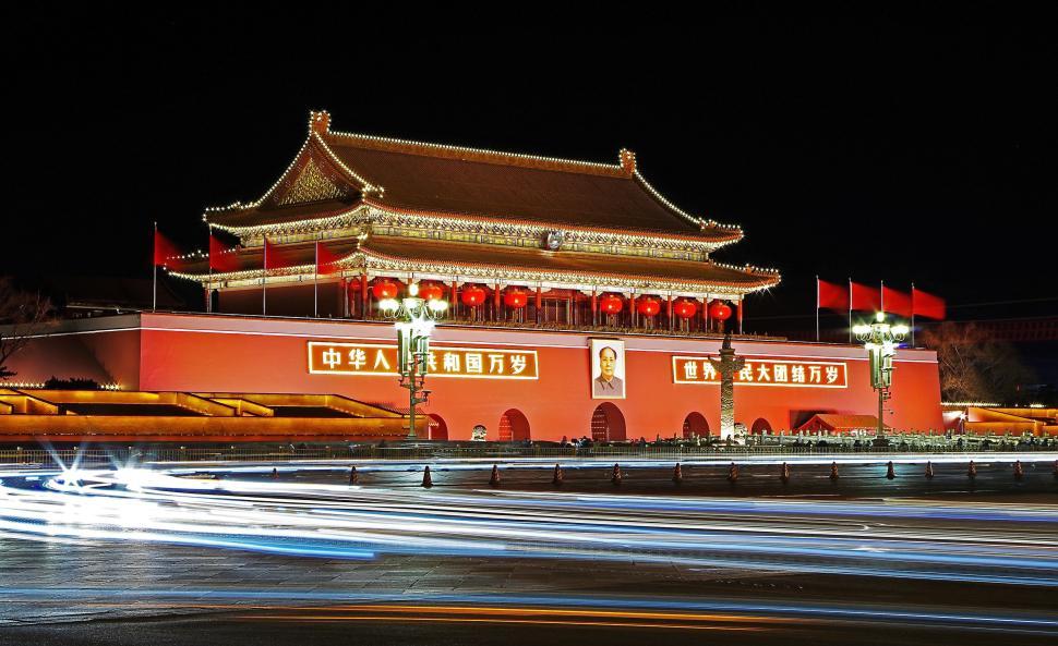 Free Image of Illuminated Tiananmen Square at night with light trails. 