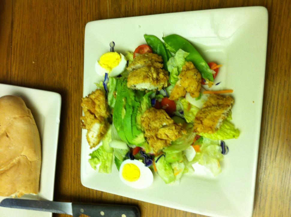 Free Image of Plate of Food and Knife on Table 