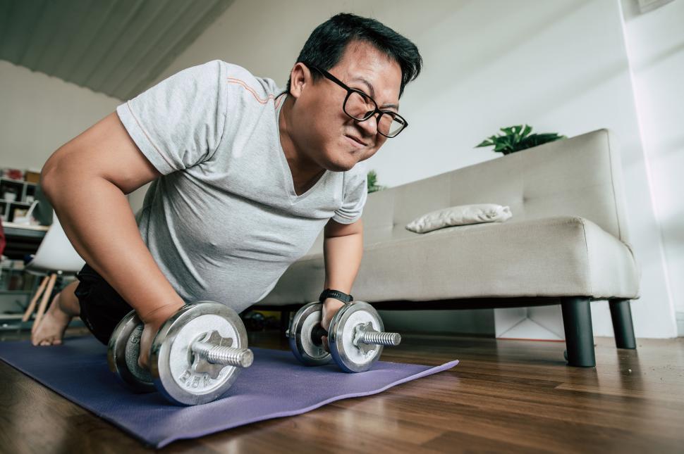 Free Image of Funny fat man workout with dummbell 