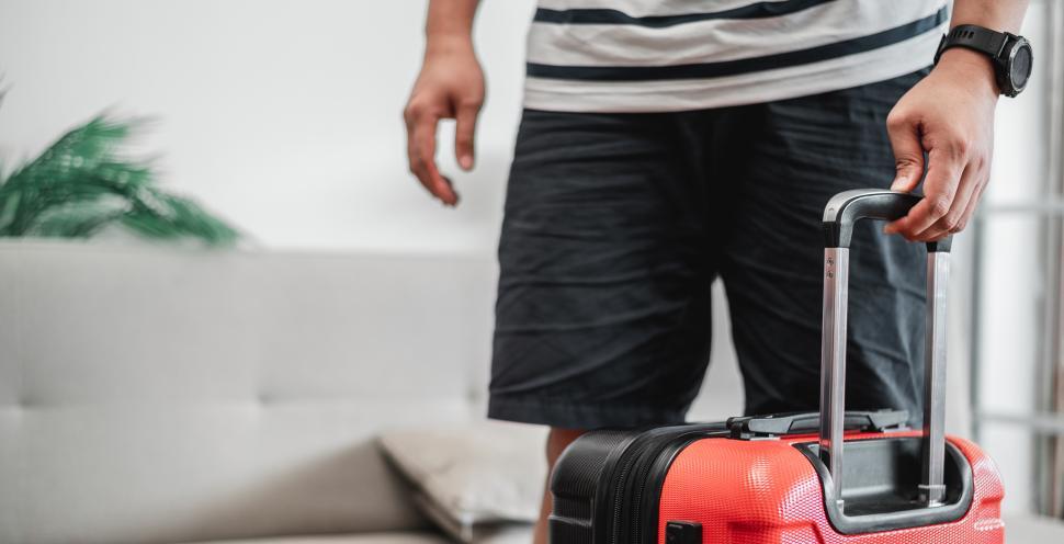 Free Image of The man has packed his luggage and is ready to go 