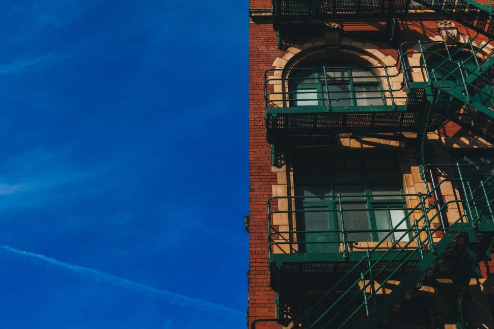 Free Image of Historic building with fire escape against clear blue sky 