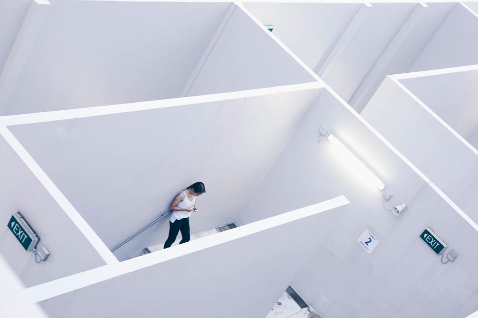 Free Stock Photo of Person navigating a minimalist white maze in a ...