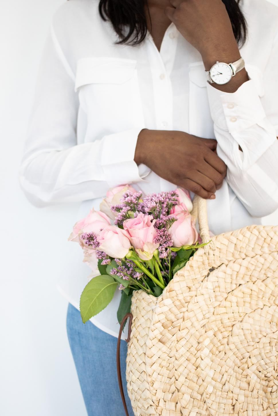 Free Image of Woman carrying a floral handbag with pink roses 
