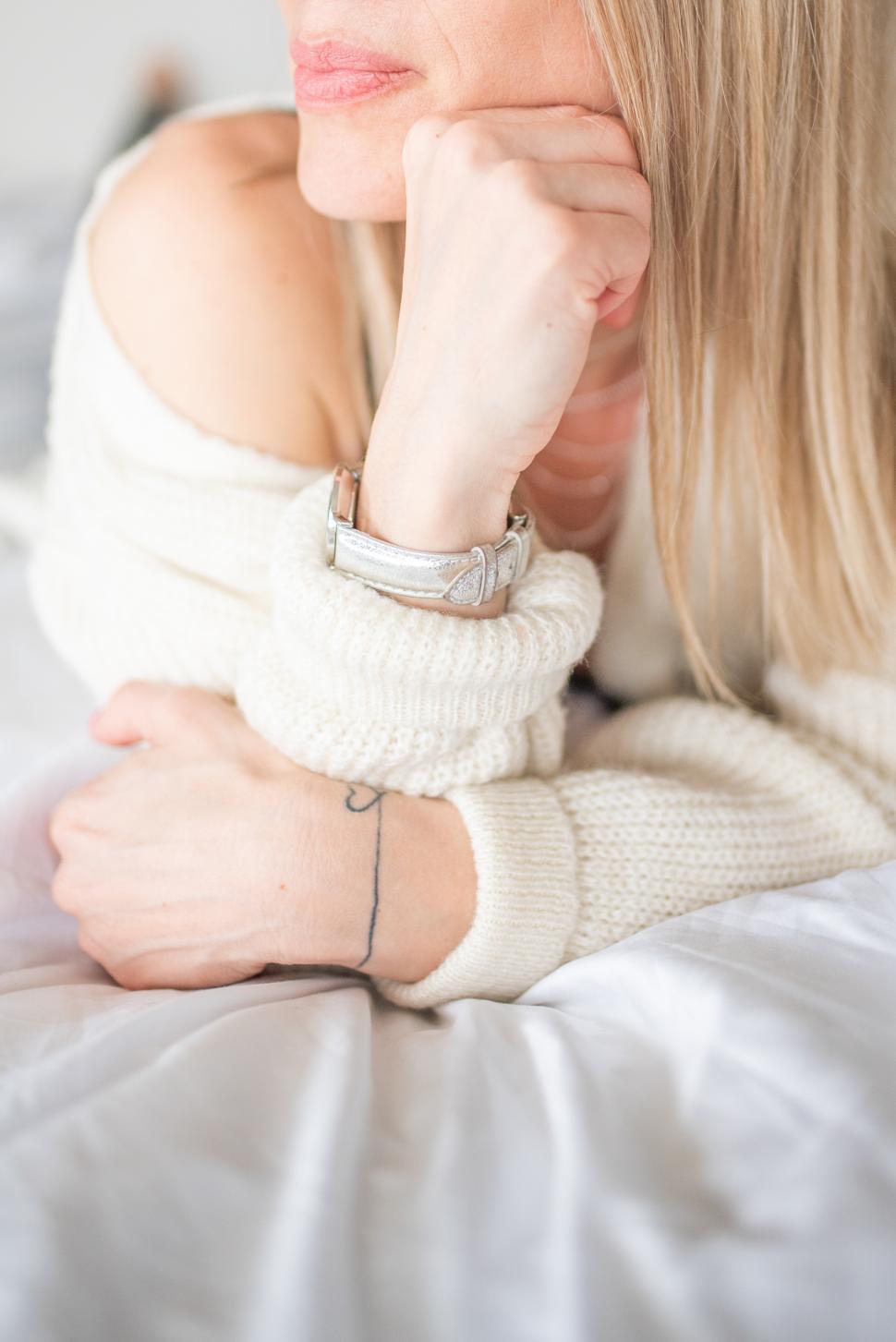 Free Image of Woman pondering quietly in cozy indoor setting 