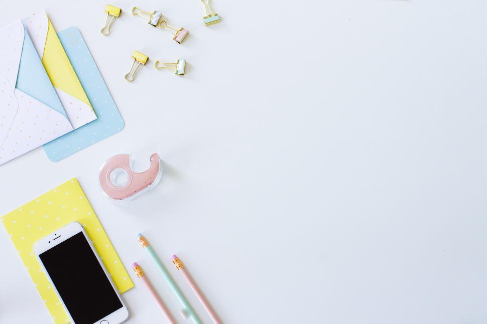 Free Image of Colorful stationery and smartphone on a clean desk 