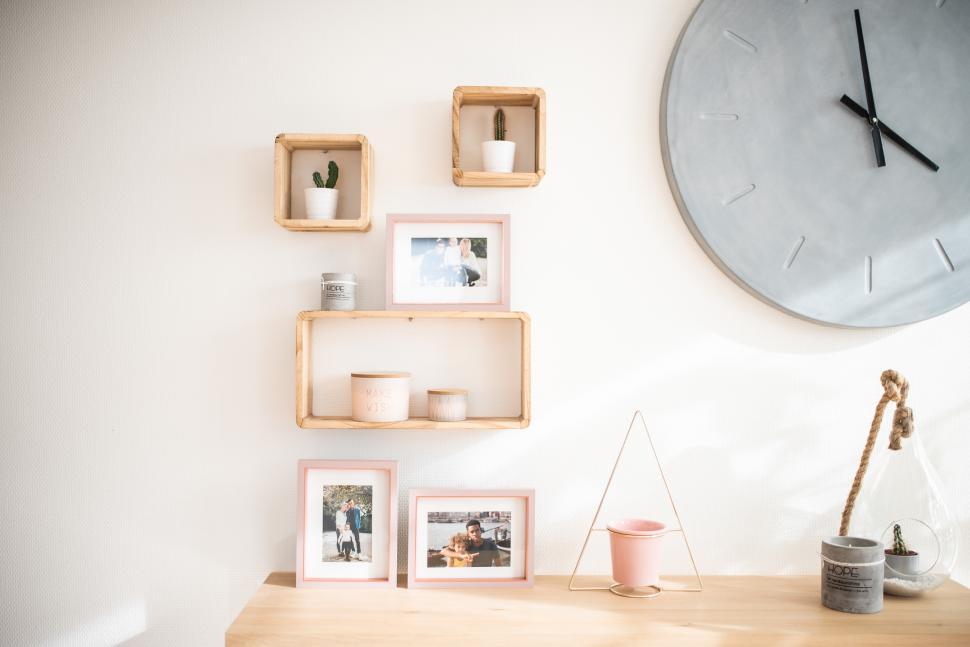 Free Image of Decorative wall display with photos and plants indoors 