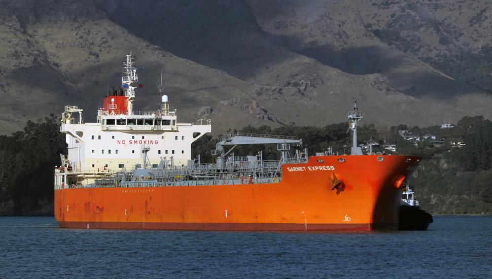 Free Image of Cargo Ship Navigates Calm Waters near Coastal Mountains 